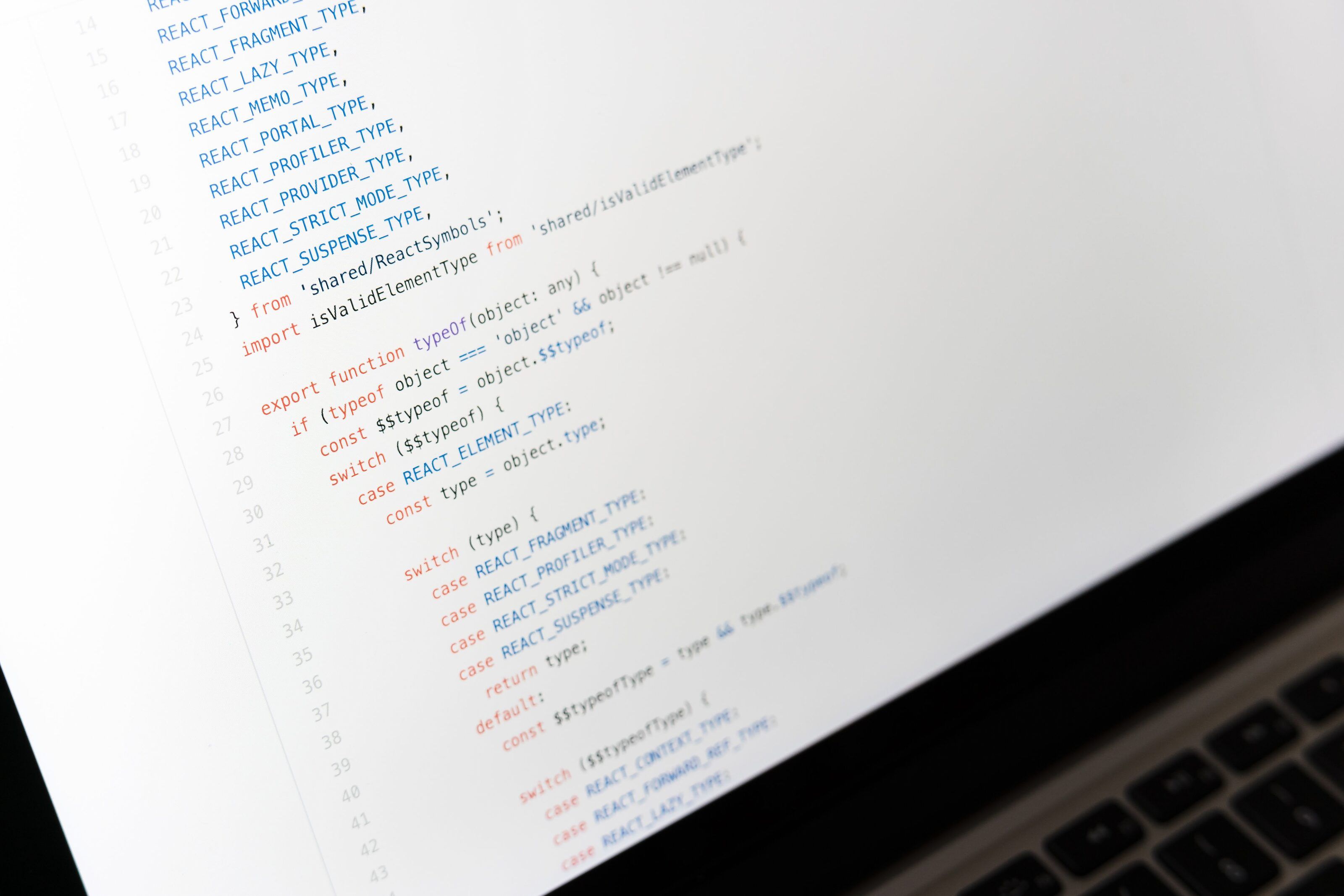 Close-up of source code in a light-theme editor on a laptop screen.